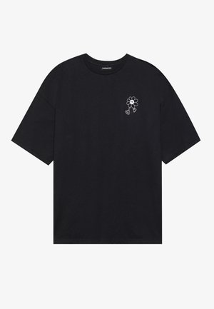 Black cotton t-shirt with short sleeves, featuring a small white flower graphic embroidered on the left chest. Classic crew neckline.