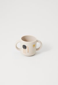 Ceramic cup with two handles, beige color, featuring an illustration of an ostrich and a sun. Smooth texture, rounded shape.