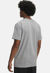 Grå bomulds T-shirt med korte ærmer, rund halsudskæring og en afslappet pasform. Glat tekstur uden synlige mønstre eller accenter.