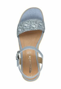Light blue sandal with an embroidered strap, buckle closure, and a tan insole. Soft material and flat sole with textured accents.