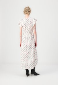 Maxi dress in lightweight fabric, white with red floral pattern, short ruffled sleeves, elastic waist, and ankle-length design.