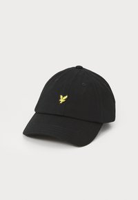 Casquette de baseball en coton noir avec une visière courbée et un logo d'aigle jaune brodé à l'avant ; six panneaux avec œillets pour la ventilation.