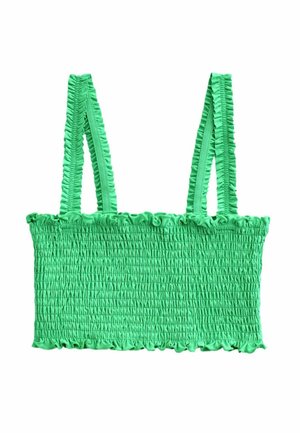 Top scurt verde aprins cu smocuri, cu bretele subțiri și volane pe umeri și margini volanate de-a lungul tivurilor de sus și de jos.