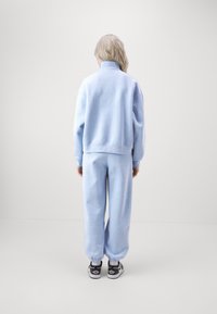 Jordan PANT - Pantalones deportivos - blue