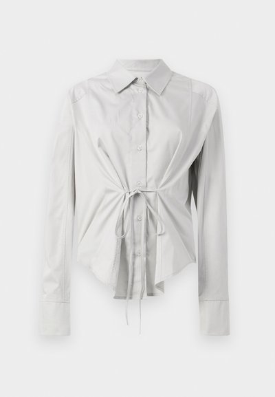 Light gray long-sleeve shirt with a fitted waist, button-up front, and tie detail at the waist. Made of smooth fabric with a classic collar.