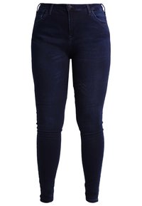 Jeans skinny de color azul oscuro, hechos de denim, con cinco bolsillos, cierre con cremallera y botón. Textura suave con un ligero desvanecimiento.