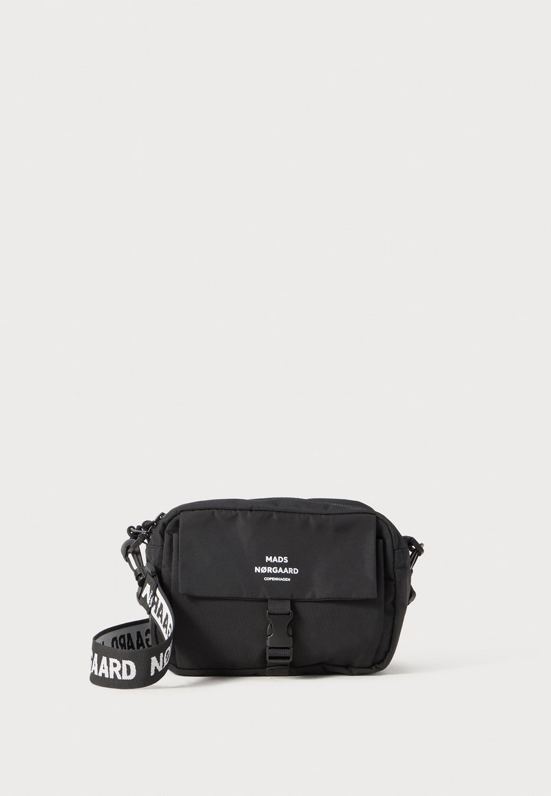 Black fabric crossbody bag with a flat shape, featuring a front flap, a buckle closure, and a logo strap. Smooth texture, minimal design.