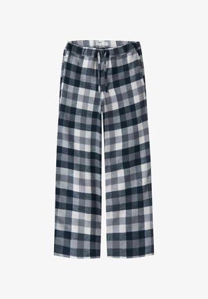 Gevlekte loungebroeken hebben zwarte, grijze en witte vierkanten, een zachte textuur, brede pijpen en een elastische tailleband met een trekkoord.
