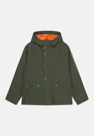Green waterproof jacket with an orange interior, adjustable hood, snap buttons, and two front flap pockets. Smooth fabric with a matte finish.