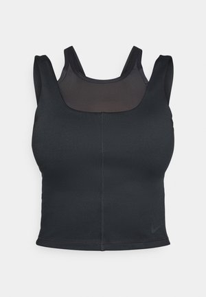 Soutien-gorge de sport noir avec une coupe ajustée, des bretelles larges et une superposition en mesh sur le devant. Texture lisse et coutures minimalistes. Logo Nike à l'ourlet.