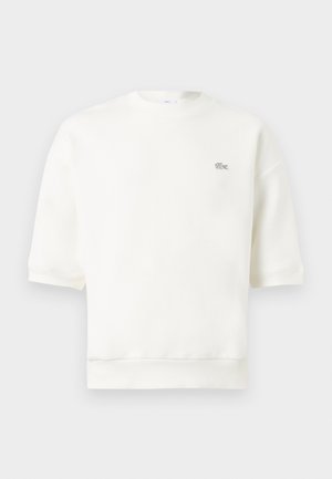 Witte sweatshirt met korte mouwen, ronde hals en klein geborduurd krokodillenlogo op de linkerborst.