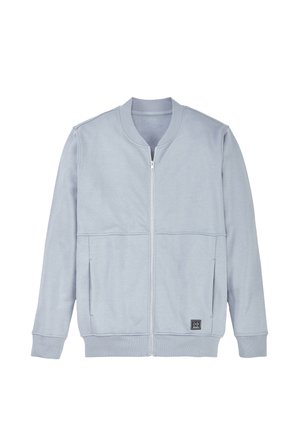 Light gray zip-up jacket with ribbed collar, cuffs, and hem, front pockets, and a small black square logo near the hem.