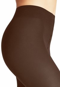 Leggings marroni a costine con vita alta, texture liscia e design aderente, evidenziando una vestibilità comoda e avvolgente.