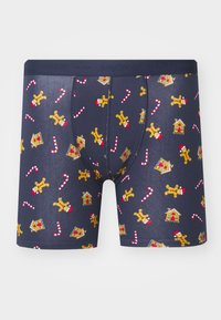 Herrenboxershorts aus navyfarbener Baumwolle mit einem Muster aus Lebkuchenmännern, Zuckerstangen und Lebkuchenhäusern. Mit elastischem Bund und figurbetontem Design.