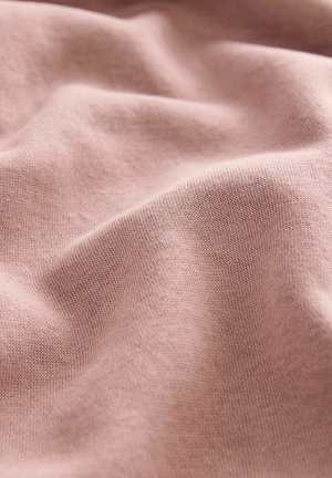 Heledad roosa puuvillane kangas sileda, pehme tekstuuriga, millel on peened langevad voldid ja lihtne kudumise muster. Nähtavad detailid või riistvara puuduvad.