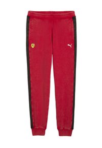 Røde sweats med sorte sidestriber. Har lommer, elastisk talje og logo detaljer: Ferrari-emblem og Puma-logo i hvid.