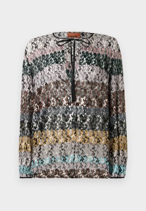Long-sleeve sweater with horizontal zigzag stripes in black, pink, green, brown, gray, yellow, and turquoise, featuring a black tie neckline.