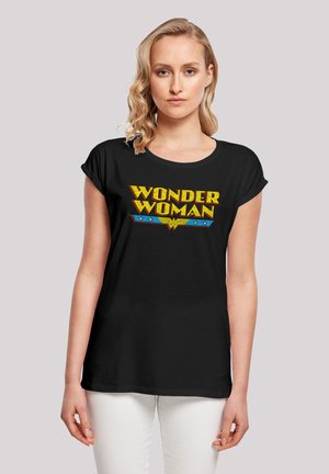 Black cotton T-shirt featuring a bold yellow and blue "Wonder Woman" graphic, short sleeves, and a relaxed fit.