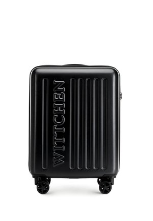 Black hard-shell suitcase with vertical grooves, embossed logo "WITTCHEN," and four black wheels for mobility. Smooth, glossy texture.