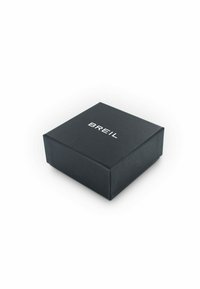 Scatola di gioielli nera con il testo bianco "BREIL" sul coperchio, posizionata su una superficie bianca.