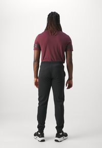 Champion ICON PANTS - Tepláky - black