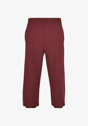 Bordové tepláky vyrobené z měkké tkaniny, s elastickým pasem a zúženými manžetami, s hladkým povrchem a bez viditelných vzorů.