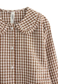 Ruskoset ja valkoiset gingham-kuosiset pitkähihainen paita, jossa pyöreä kaulus ja valkoiset napit edessä, koko pieni, merkki Lindex.