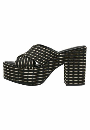 Black platform slide sandals with cross-over straps, featuring a textured pattern of white lines. Chunky, square heel for added height.