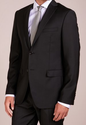 Black tailored suit jacket with narrow lapels, two buttons, and front pockets. Worn over a white dress shirt and gray tie. Smooth fabric texture.