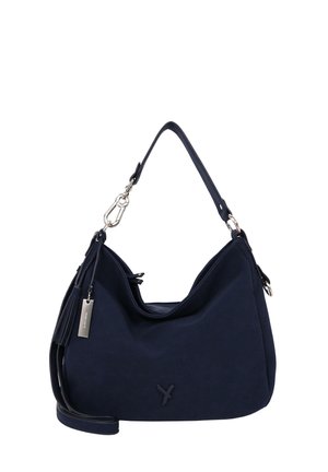 Sac d'épaule bleu marine avec sangle ajustable, fermoir argenté, détail à pompon et logo discret de la marque sur une surface douce et texturée.