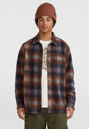Flannel shirt featuring a plaid pattern in dark blue, orange, and gray tones, button-up front, a chest pocket, and soft texture.