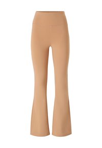 Beige flared leggings lavet af strækbart stof med en glat tekstur og høj talje. Har rene linjer og ingen synlige mønstre.