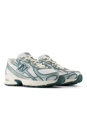 White mesh running shoes with teal accents, textured surfaces, a cushioned sole, and logo detail on the side and heel. Neutral design.