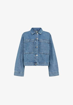 Heledamisotükk helehallidest teksakraest, millel on kaks eesmist taskut, hõbedased nupud ja klassikaline kaelus; Omab õmmeldud õmblusi ja laiad varrukad.