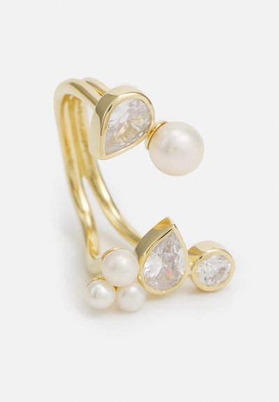 Gold ring with two teardrop-shaped clear stones, one large pearl, and three smaller pearls, featuring a smooth, polished finish.