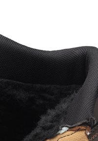 Black fabric lining with a wool texture and tan leather edge; features a smooth transition between materials and a rounded opening.