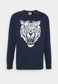 Sweat-shirt bleu marine en tissu doux, avec un graphisme blanc représentant une tête de tigre, accompagné du texte "Schott Fighting Spirit" et du numéro 13.