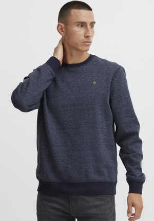 Navy blue sweatshirt with a round neck, long sleeves, and ribbed cuffs. Features a subtle texture and a small logo on the chest.