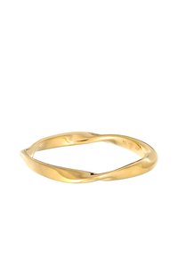 Twisted gold metal bangle with a smooth, shiny texture. Features a minimalist design with rounded edges and uneven wave-like curves.