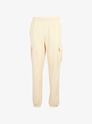 Pantalons cargo de couleur crème avec une taille élastique, des poches latérales et des poignets élastiques aux chevilles. Fabriqués dans un tissu doux et léger.