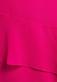 Fuchsia fabric with a smooth texture, featuring layered ruffles and a clean, stitched hemline. No visible patterns or hardware.