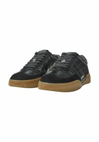 Black sneakers featuring a textured, patterned upper with suede accents, round toe, and a gum rubber sole. Laces in a matching dark color.