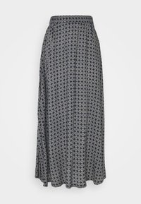 Jupe maxi navy en tissu doux, présentant un motif géométrique avec des accents circulaires et une taille élastique pour plus de confort.