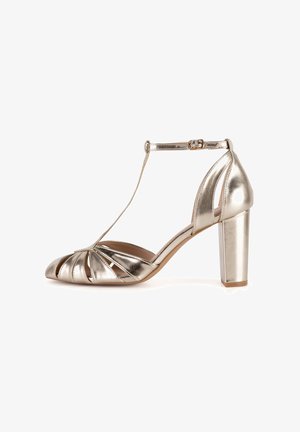 Metallic gold high-heeled sandal with an ankle strap, open toe, and pleated design across the front. Chunky block heel for stability.