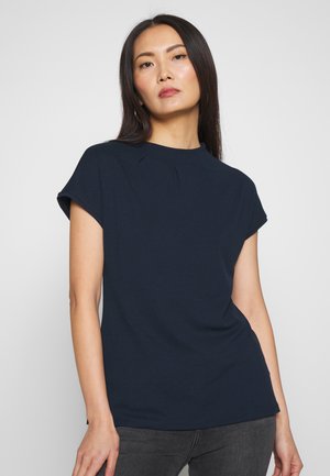 Navy blue short-sleeve top with a round neckline and subtle pleat detail at the front. Smooth fabric, relaxed fit, and casual design.