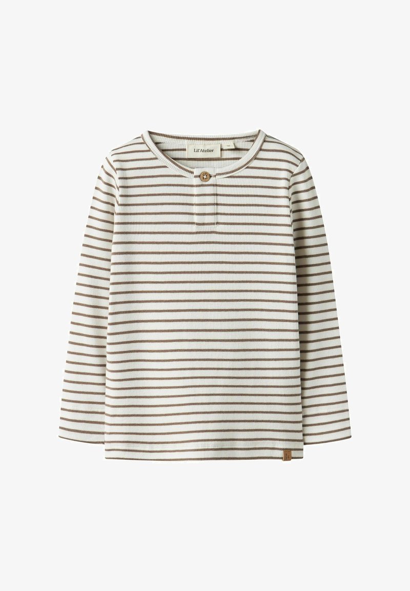 Bluzka w paski z długim rękawem w kolorach kremowym i brązowym. Posiada zapinaną na guziki listwę, prążkowaną fakturę oraz małą metkę z logo przy krawędzi.