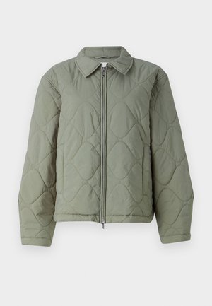 Green quilted jacket with a zip closure, featuring a collared neck and rounded shapes. Textured material, relaxed fit, and elastic cuffs.