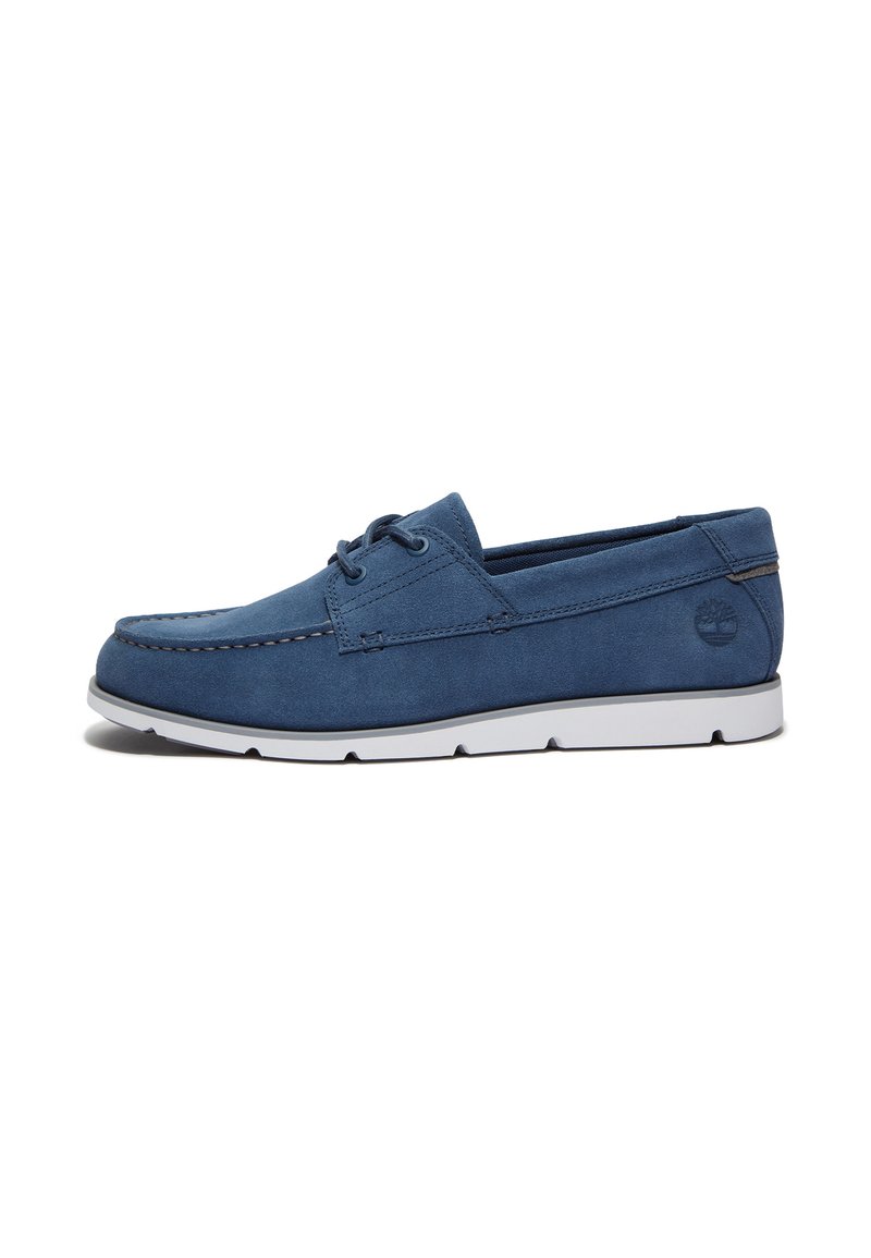 Pánske modré velúrové lodné topánky s bielou gumovou podrážkou, šnurovací dizajn a viditeľné švy. Logo Timberland na boku.