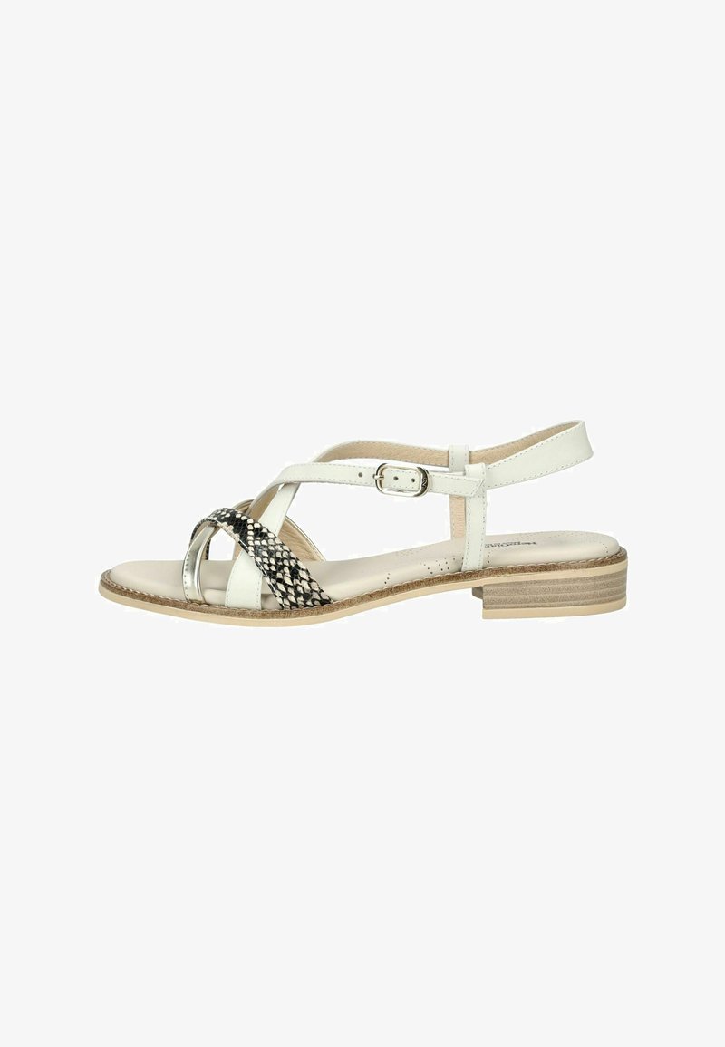 White flat sandal with a low stacked heel, adjustable ankle strap, and black-and-white snakeskin patterned cross straps.