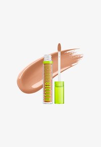 Tube de correcteur liquide avec bouchon vert citron et applicateur, échantillon de teinte nude derrière sur fond blanc.